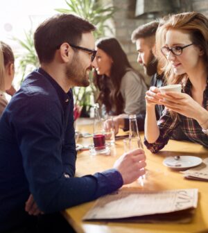 Handsome man flirting with cute woman in restaurant
