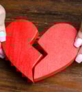 A woman collects a broken heart in his hands