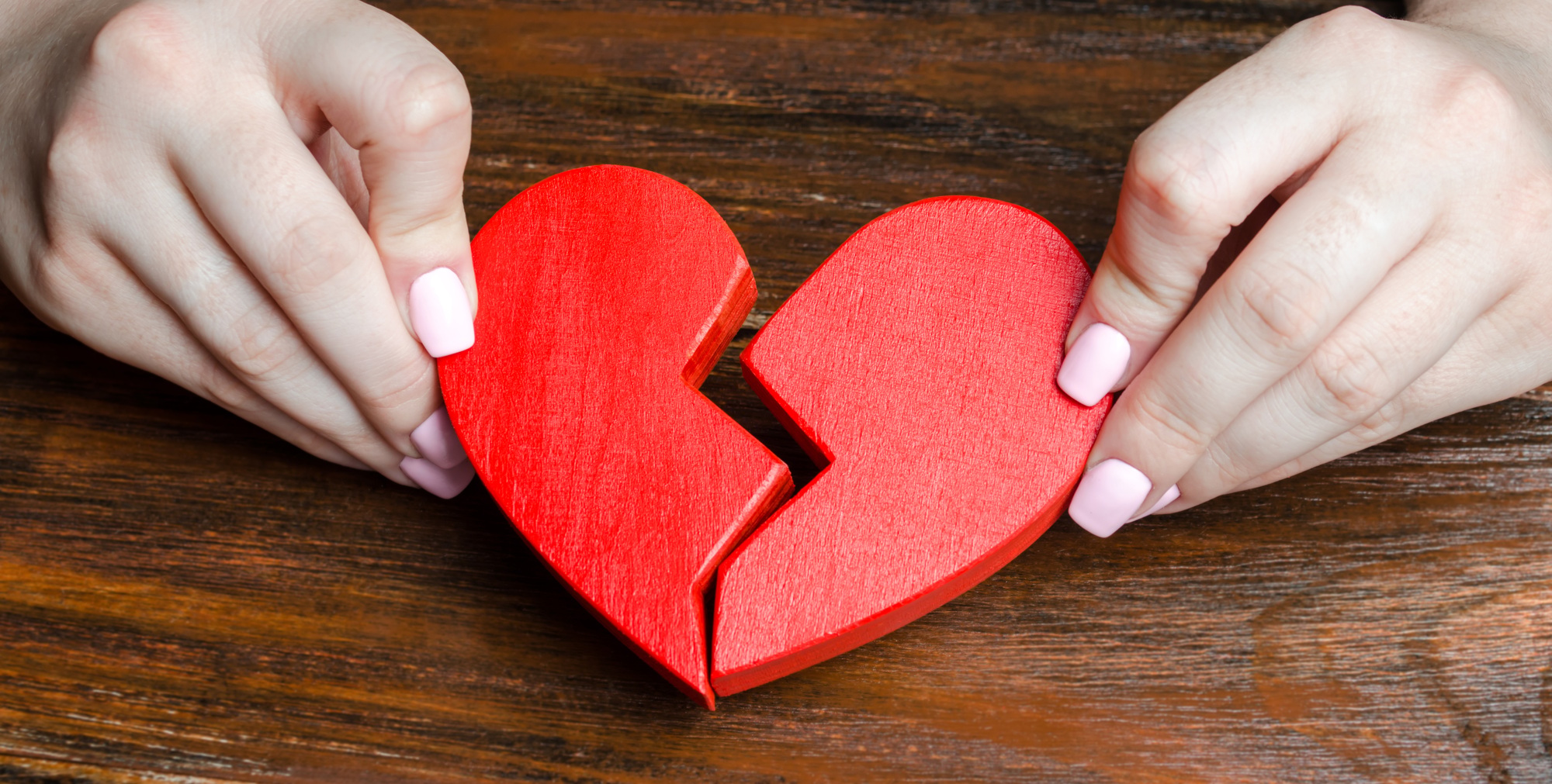 A woman collects a broken heart in his hands
