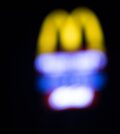 Blurred background of McDonald’s signage at night