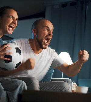 Football fans watching a match on TV