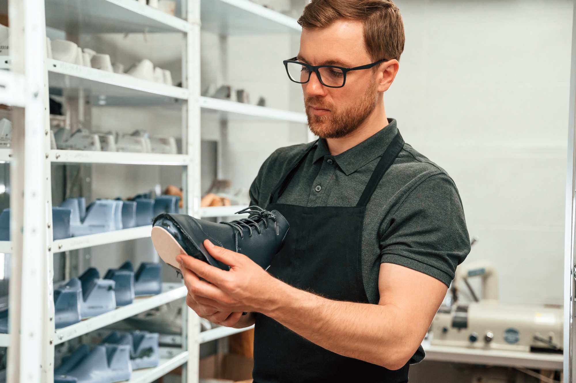 In search for right size for the shoe. Man is working indoors