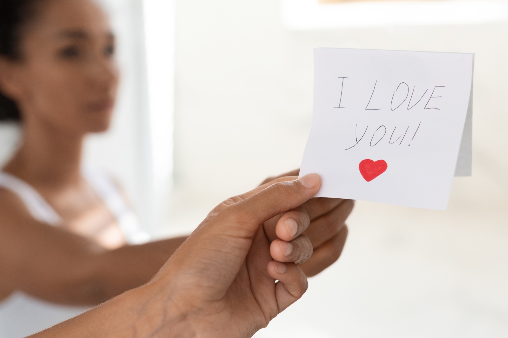 Woman Taking Off Sticky Note With I Love You Text On Mirror