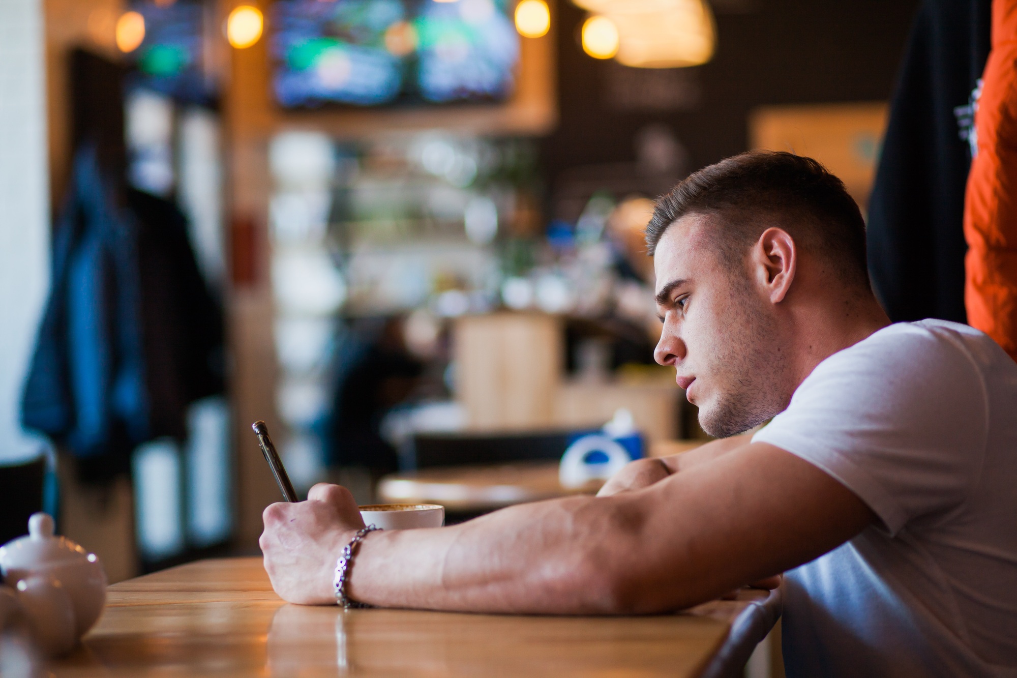 Young man use texting message in cafe.